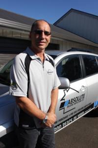 John Le Prou beside his Absolute Building Inspections vehicle